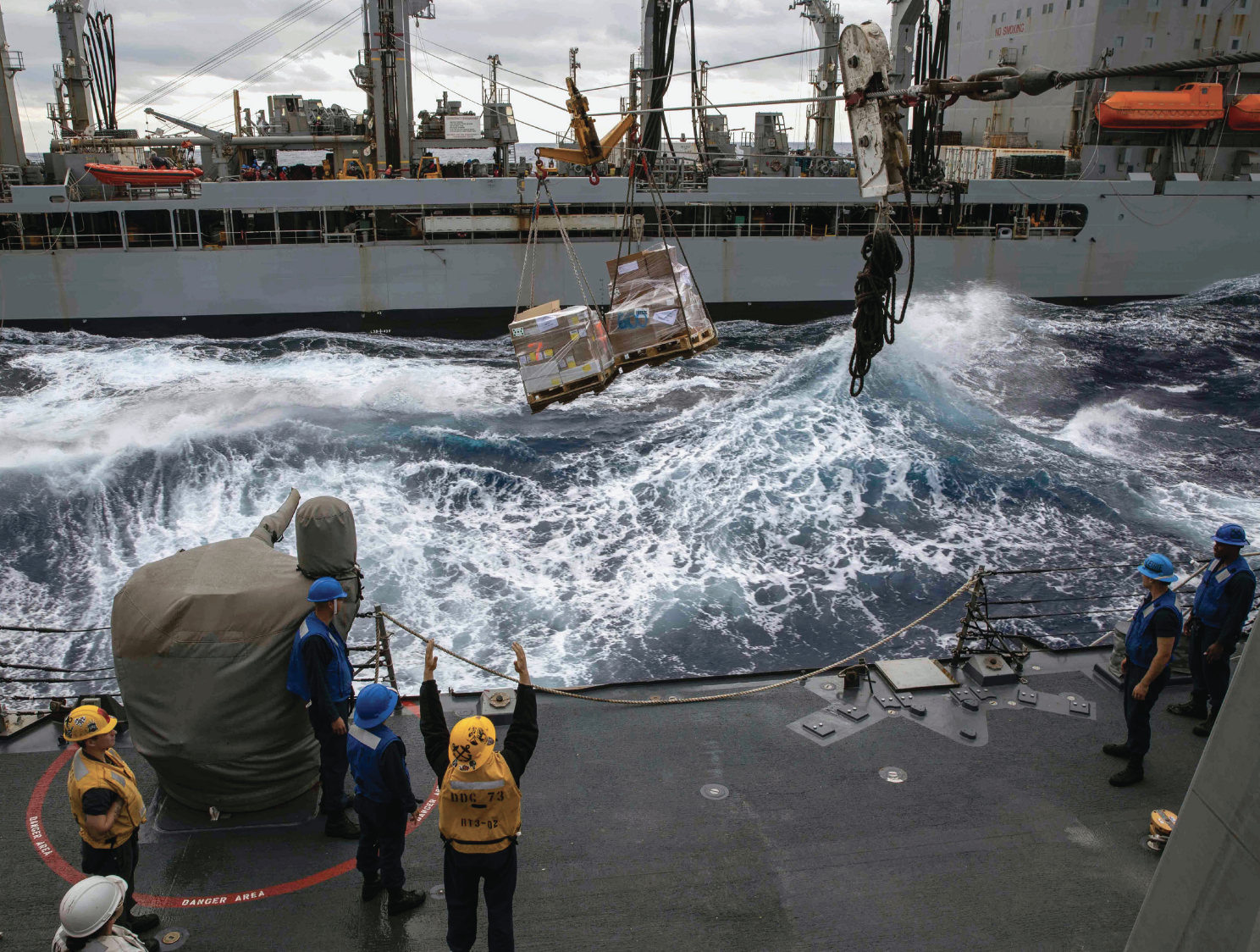 Sailors receive pallets from fleet replenishment oiler USNS Guadalupe during replenishment-at-sea aboard guided-missile destroyer USS Decatur,Philippine Sea, December 28, 2022 (U.S. Navy/David Negron)
